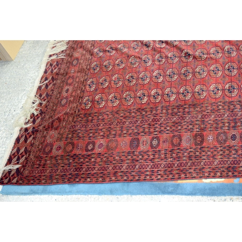 3136 - A Large red ground Oriental rug.  350cm x 250cm