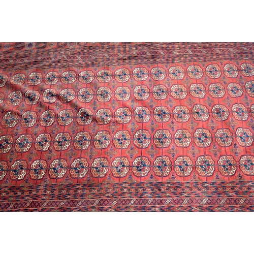 3136 - A Large red ground Oriental rug.  350cm x 250cm