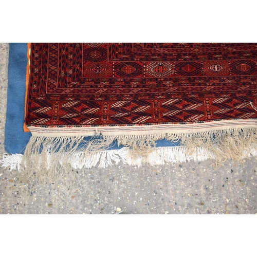 3136 - A Large red ground Oriental rug.  350cm x 250cm