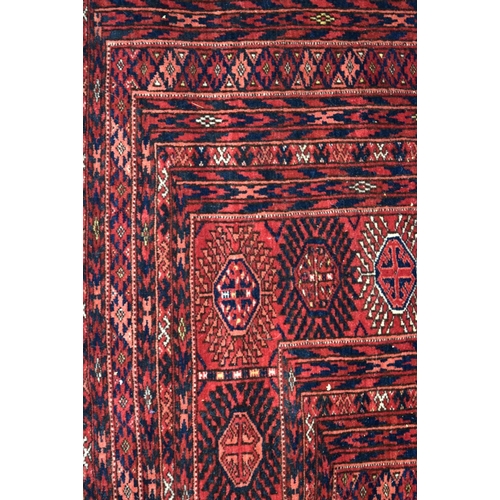 3136 - A Large red ground Oriental rug.  350cm x 250cm