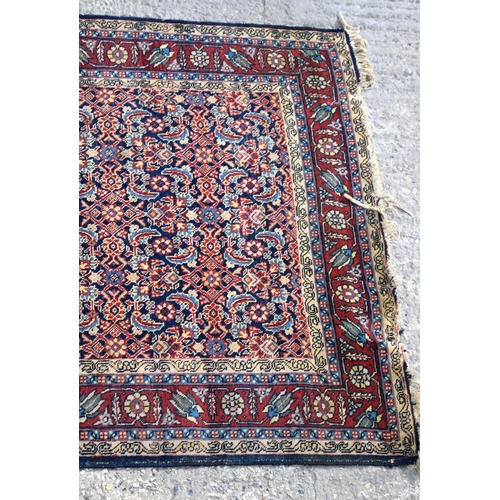 3143 - A Turkman red ground rug.  190cm x 140cm