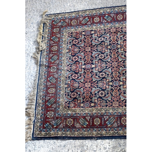 3143 - A Turkman red ground rug.  190cm x 140cm