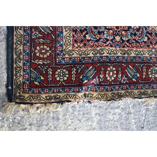 3143 - A Turkman red ground rug.  190cm x 140cm