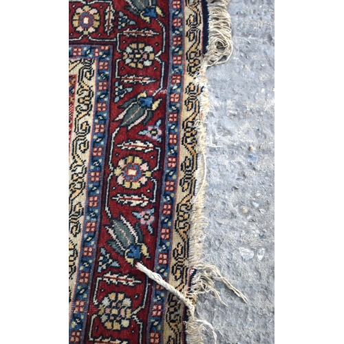 3143 - A Turkman red ground rug.  190cm x 140cm