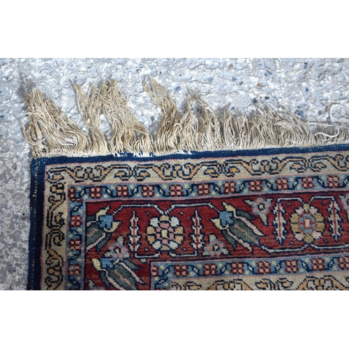 3143 - A Turkman red ground rug.  190cm x 140cm