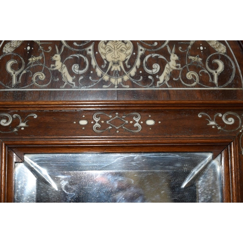 3182 - An Antique continental bevelled glass Mirror with wooden ivory inlaid frame.  108cm x 60cm