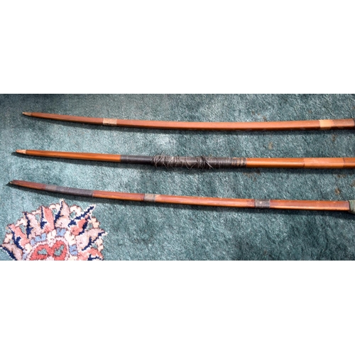 3235 - Three early 20th Century Archery bows.  largest 187cm long