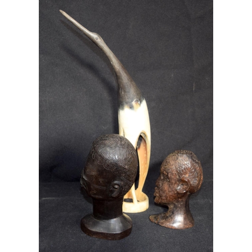 3236 - A scarified African Hardwood head together with another similar and a horn bird