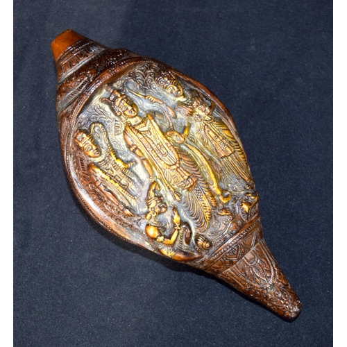 3243 - A Tibetan bronze snail shell decorated with figures.  24cm x 12 cm