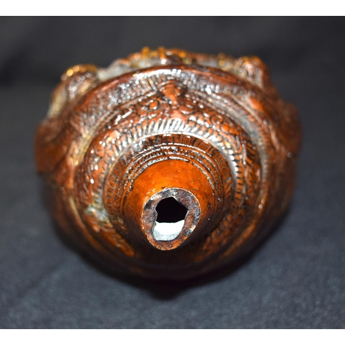 3243 - A Tibetan bronze snail shell decorated with figures.  24cm x 12 cm