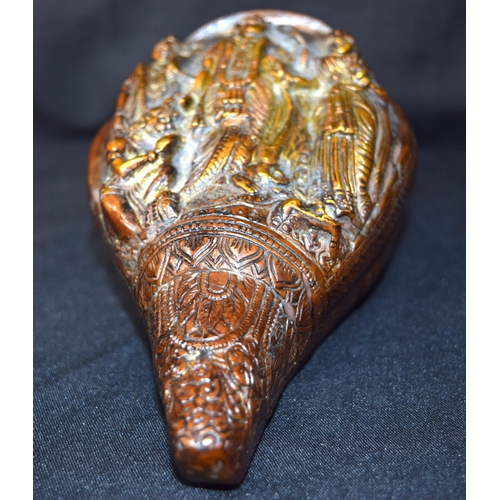 3243 - A Tibetan bronze snail shell decorated with figures.  24cm x 12 cm