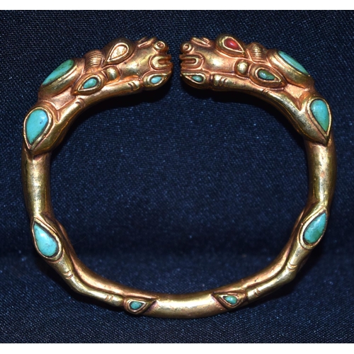 3277 - A Chinese Tibetan gilt metal dragon bangle, Turquoise stones 7.5 cm x 7cm