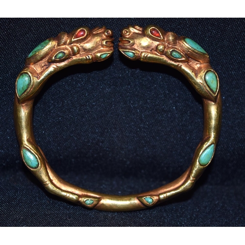 3277 - A Chinese Tibetan gilt metal dragon bangle, Turquoise stones 7.5 cm x 7cm