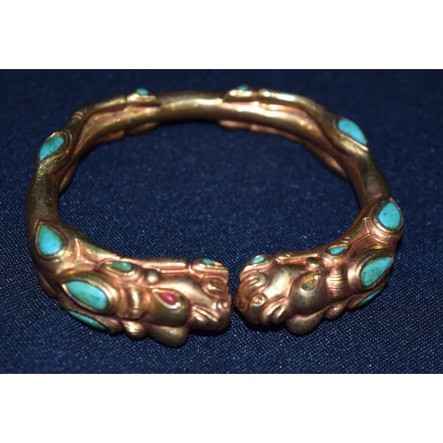 3277 - A Chinese Tibetan gilt metal dragon bangle, Turquoise stones 7.5 cm x 7cm