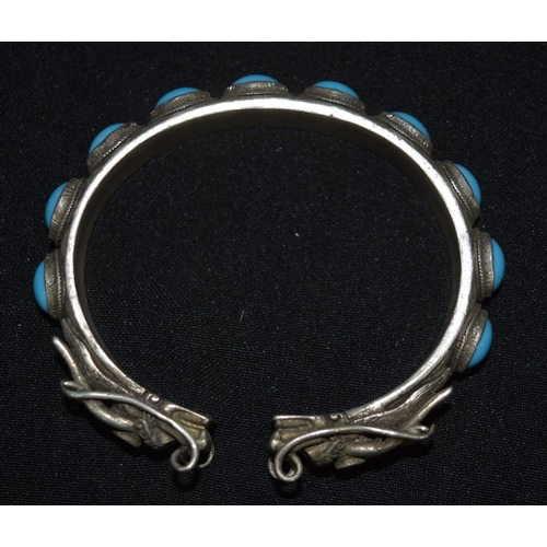 3288 - A Chinese White metal dragon Bangle with Turquoise stones