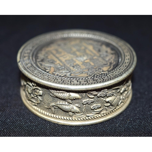 3300 - A Chinese white metal embossed coin box 5 x 2 cm