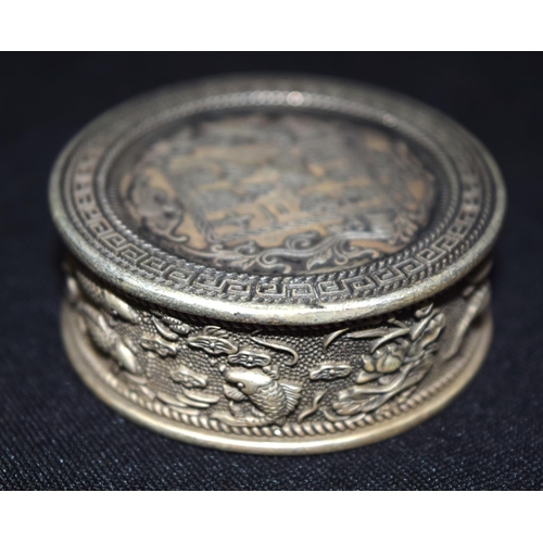 3300 - A Chinese white metal embossed coin box 5 x 2 cm