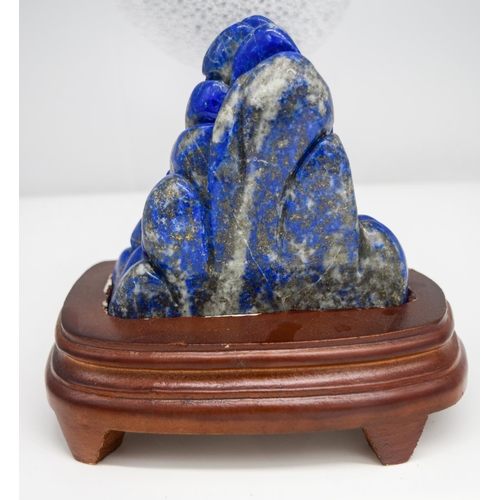 3468 - A Lapis lazuli carved boulder with stand 12 x 12 cm