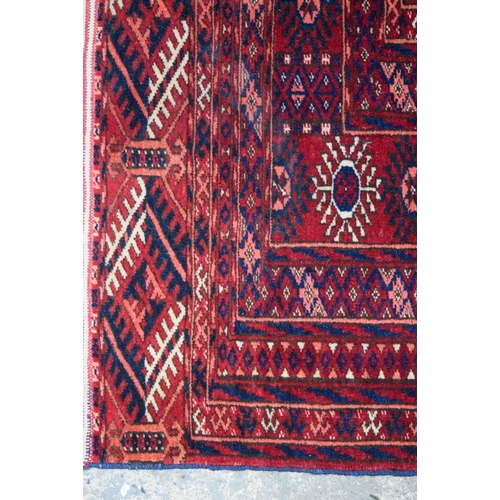 3140 - A Red ground Oriental rug.  176cm x 122cm