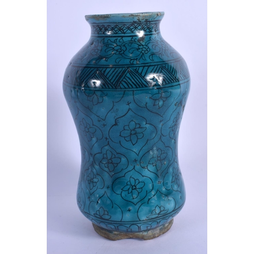 435 - AN EARLY MIDDLE EASTERN KASHAN ISLAMIC TURQUOISE GLAZED ALBARELLO JAR painted with flowers. 21.5 cm ... 