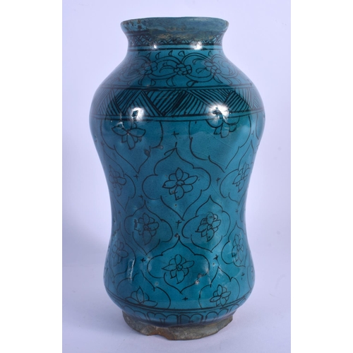 435 - AN EARLY MIDDLE EASTERN KASHAN ISLAMIC TURQUOISE GLAZED ALBARELLO JAR painted with flowers. 21.5 cm ... 