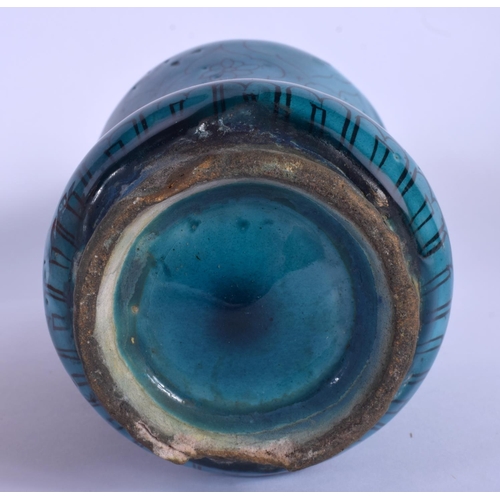 435 - AN EARLY MIDDLE EASTERN KASHAN ISLAMIC TURQUOISE GLAZED ALBARELLO JAR painted with flowers. 21.5 cm ... 