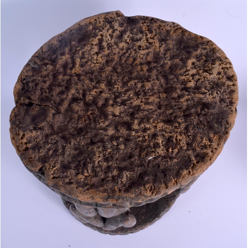 8 - AN EARLY 20TH CENTURY AFRICAN YORUBA TRIBAL STOOL formed with four opposing figures. 38 cm x 26 cm.