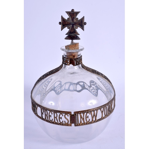 12 - AN UNUSUAL EARLY 20TH CENTURY NEW YORK FORBIDDEN FRUIT LIQUEUR DECANTER with cross finial. 19 cm x 1... 