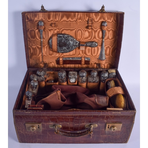 1261 - A LOVELY ANTIQUE GENTLEMAN'S TRAVELLING SUITCASE inset with silver items, including a carriage clock... 