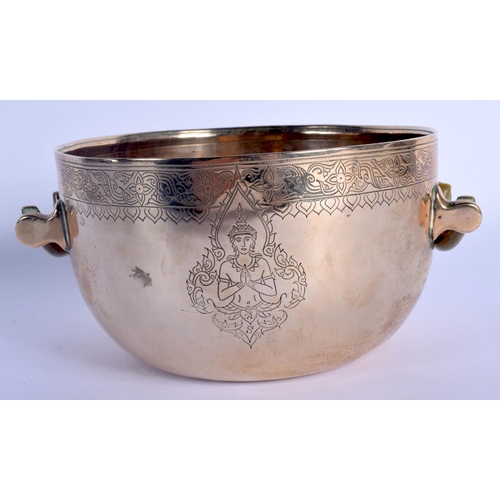 1562 - A 19TH CENTURY INDO TIBETAN TWIN HANDLED POLISHED BRASS CENSER with carved rhinoceros horn handles, ... 