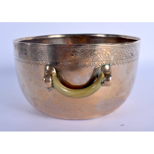 1562 - A 19TH CENTURY INDO TIBETAN TWIN HANDLED POLISHED BRASS CENSER with carved rhinoceros horn handles, ... 