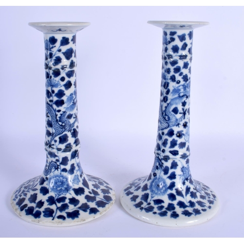 1564 - A PAIR OF 19TH CENTURY CHINESE BLUE AND WHITE PORCELAIN CANDLESTICKS Qing, painted with dragons amon... 