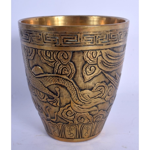 1599 - A 19TH CENTURY CHINESE BRONZE BEAKER FORM VASE Qing, decorated with dragons. 11 cm high.