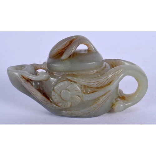 1619 - A CHINESE GREEN JADE TEAPOT AND COVER 20th Century, overlaid with foliage. 8 cm wide.