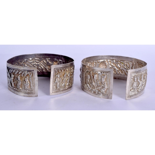 1655 - A PAIR OF 19TH CENTURY CHINESE EXPORT SILVER BANGLES Qing, decorated with figures and motifs. 79 gra... 