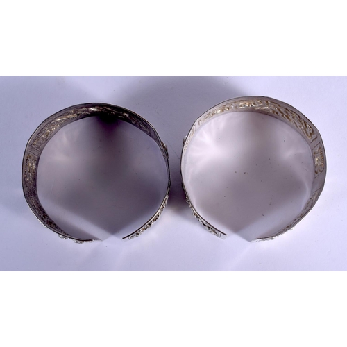 1655 - A PAIR OF 19TH CENTURY CHINESE EXPORT SILVER BANGLES Qing, decorated with figures and motifs. 79 gra... 