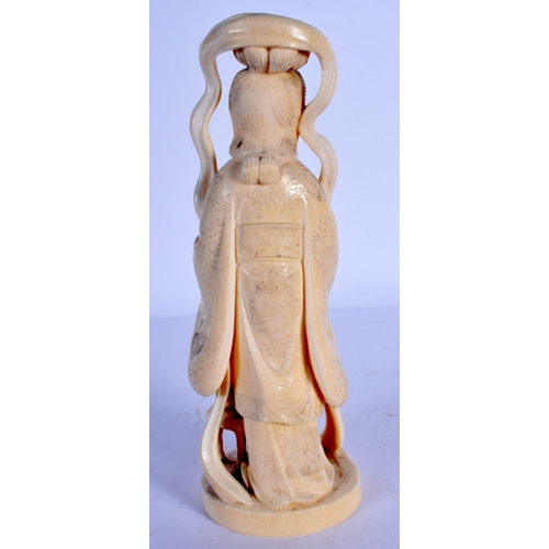 1694 - A 19TH CENTURY JAPANESE MEIJI PERIOD CARVED IVORY OKIMONO modelled holding a fan. 21 cm high.