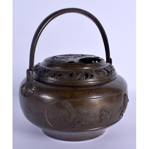 1710 - A LARGE 19TH CENTURY CHINESE BRONZE HAND WARMER AND COVER decorated with openwork figures and landsc... 