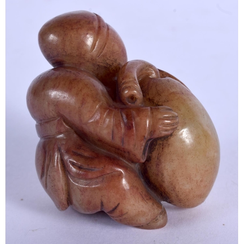 1737 - A 19TH CENTURY CHINESE CARVED MUTTON JADE FIGURE OF A BOY Qing, modelled clutching fruit. 4.5 cm x 5... 