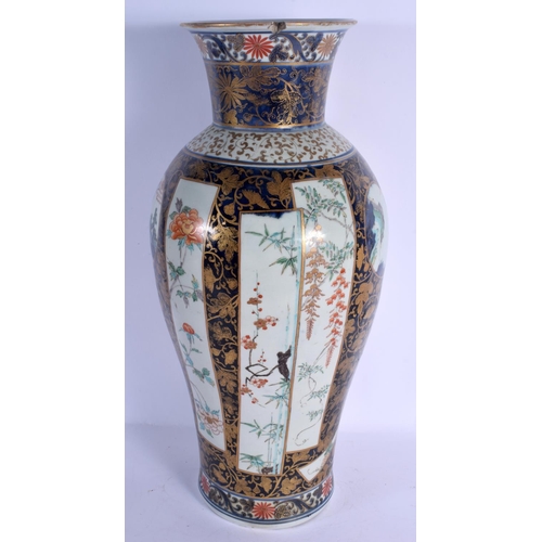 1742 - A RARE LARGE 18TH CENTURY JAPANESE EDO PERIOD IMARI BALUSTER VASE painted with buildings and landsca... 