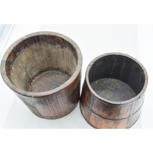 4080 - A 19th century metal banded oak barrel together with another largest 23 x 25.5cm.