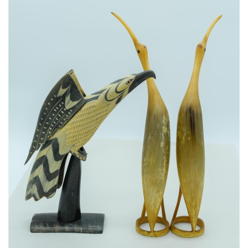 4084 - A collection of carved Horn birds including an Eagle largest 37cm.