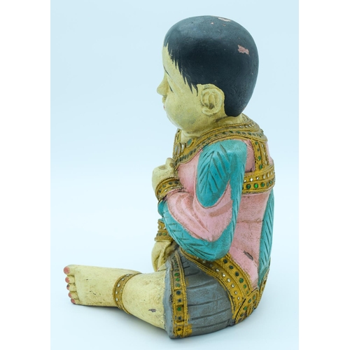 4134 - A decorated wooden  figure of an Asian Boy 31 x  22cm.