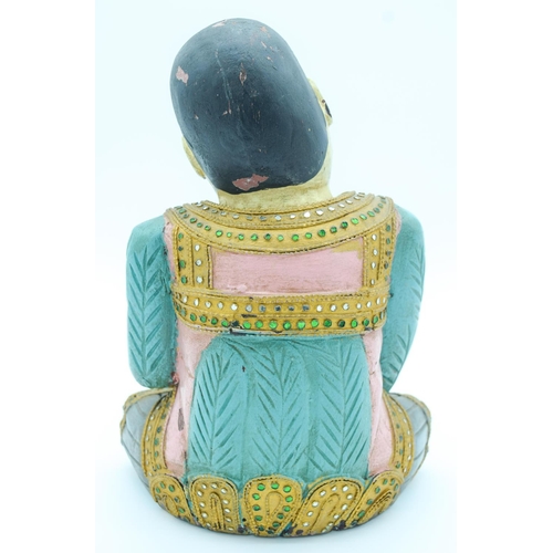 4134 - A decorated wooden  figure of an Asian Boy 31 x  22cm.