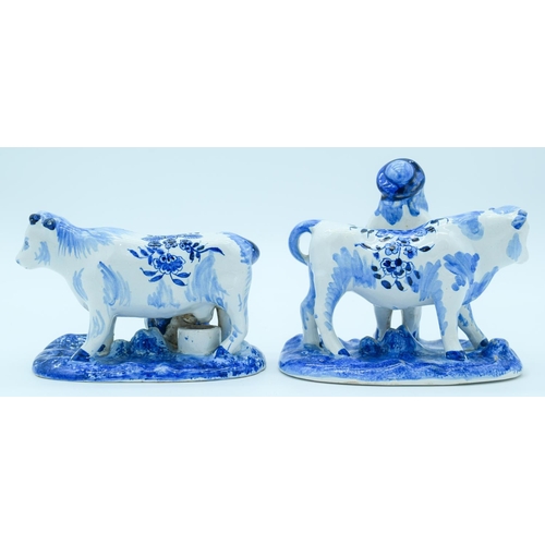 4145 - Two Delft pottery figures of Cows and farm hands 13 x 16 cm (2).