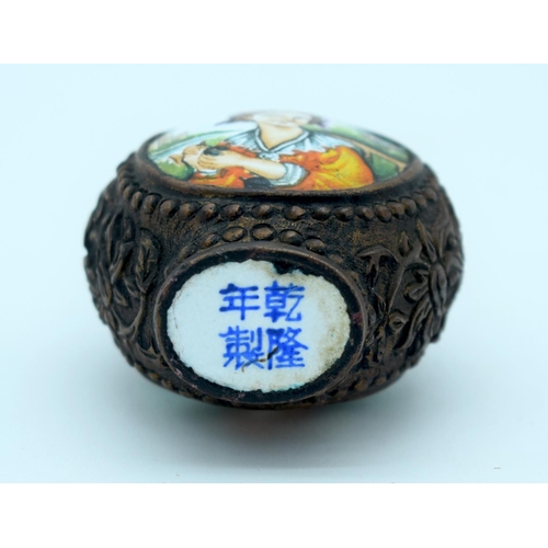 4205 - A metal snuff bottle with an enamelled painted picture of a woman 8 x 5cm.