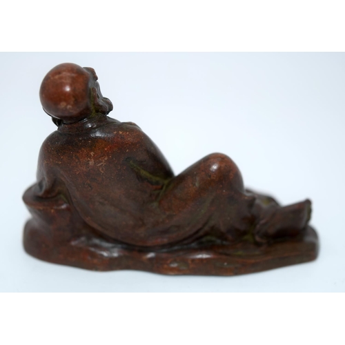 4237 - A Japanese small bronze figure of a reclining male  12cm.