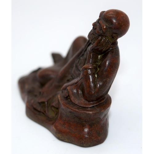 4237 - A Japanese small bronze figure of a reclining male  12cm.