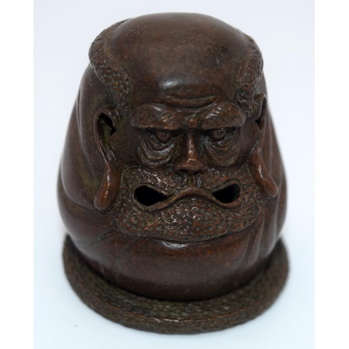 4239 - A Japanese small bronze figure of a grotesque head  12cm (2).