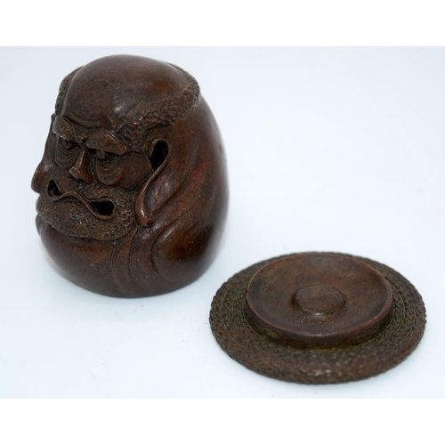 4239 - A Japanese small bronze figure of a grotesque head  12cm (2).